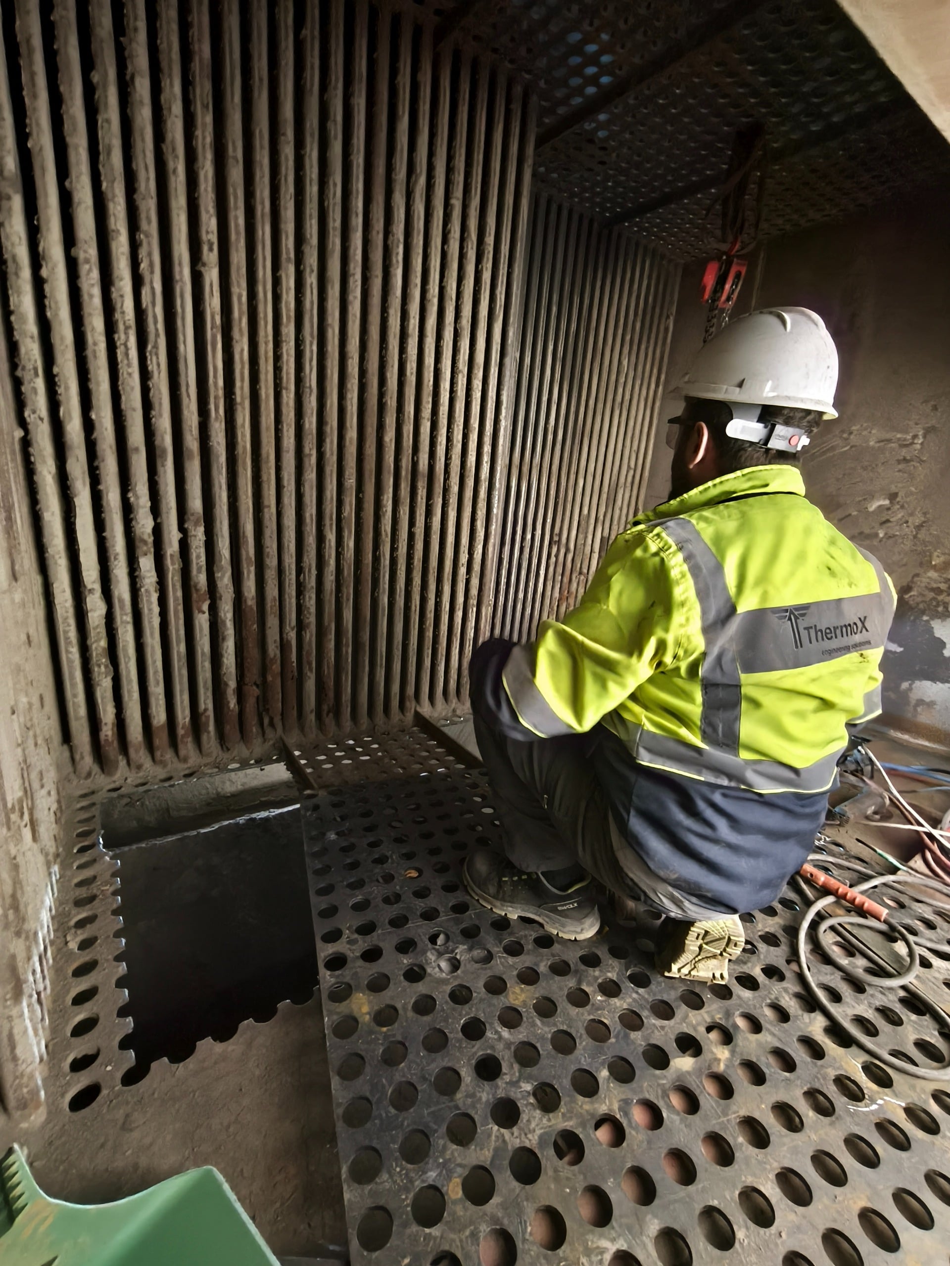 A ThermoX field team member inspecting boiler tubes